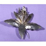 A silver brooch fashioned as an orchid