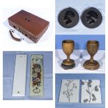A small leather case, two wood goblets and stands, a pair of medallions, finger plates and tiles