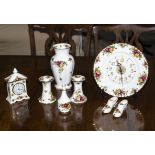 A Royal Albert 'Old Country Roses' wall clock, candle sticks, bud vase, shoes, mantle clock and a