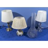 Three table lamps and a glass bottle vase