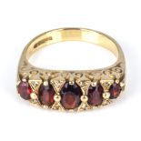 A lady's 9ct gold ring set with five garnets, size P