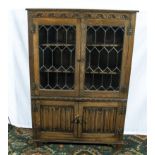 A glazed oak bookcase on cupboards 95cm x 32cm x 137cm tall