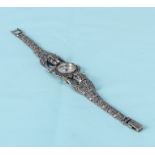 A lady's French marcasite and silver dress wristwatch with leopard shoulders