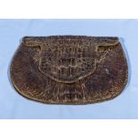 A vintage crocodile skin purse