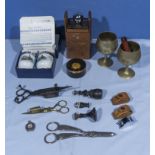 A collection of vintage items including candle snuffers, grape scissors, seals and others