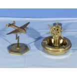 A brass bomber aeroplane desk decoration together with a brass nautical ash tray