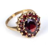 A lady's 9ct gold ring set with garnets, size N