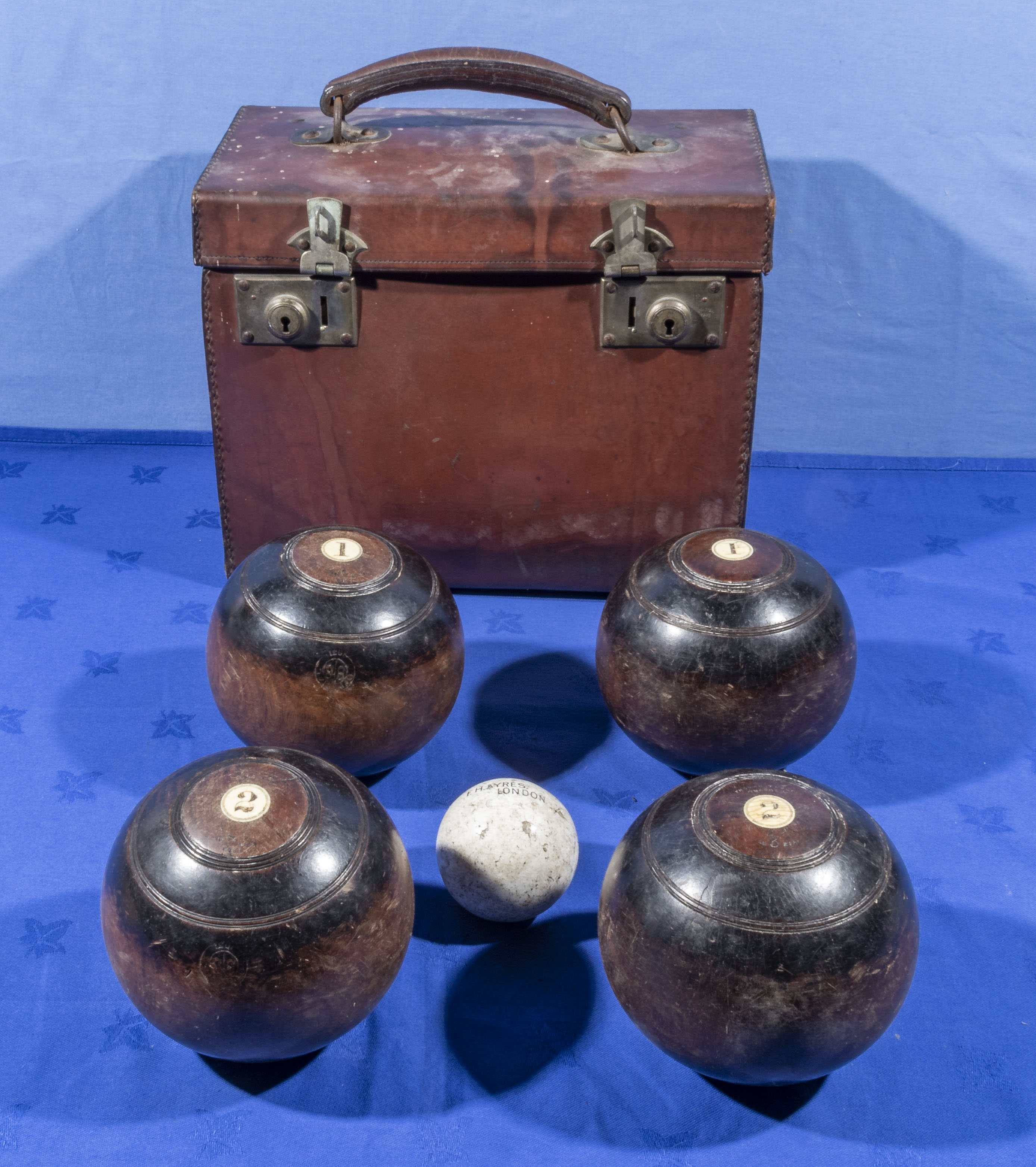 A leather bowl carrier, numbers 1 and 2 woods