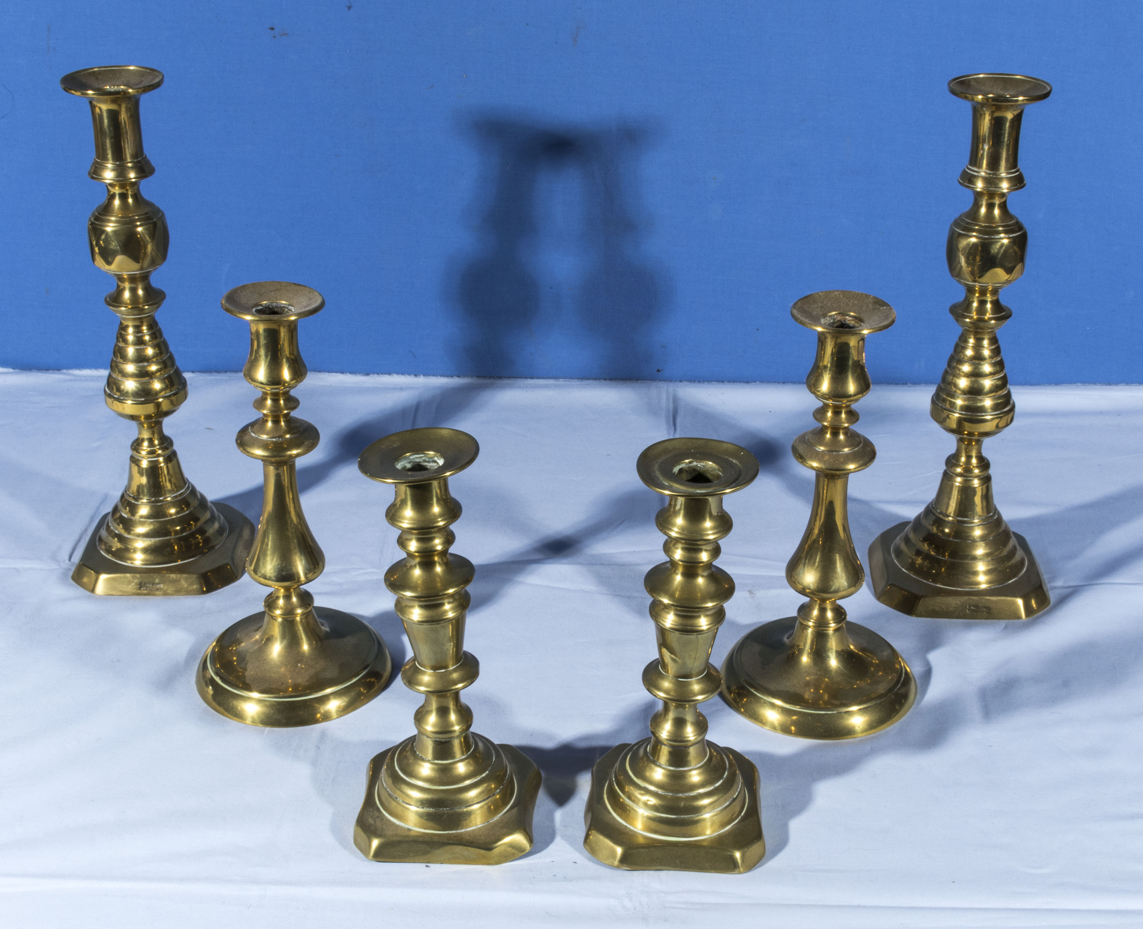 Three pairs of brass candlesticks