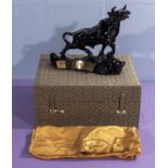 A Chinese white metal sculpture of a bull in a fitted silk lined box