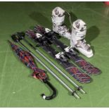 A pair of BUZZ 99 snow blades together with poles and a pair of Salomon Quest ski boots size 25