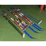 Two pairs of Alpine Trak skis together with poles, shoes and goggles