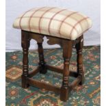 An upholstered oak framed stool