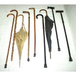 Canes, walking sticks and two umbrellas