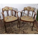 A pair of mahogany arm chairs with tapestry seats and back