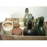 A box containing bottles and earthenware jars