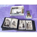 A photograph album containing snapshots from 1920's together with postcards and cigarette cards