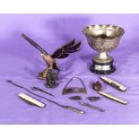 A silver plated cup, silver bottle label, penknives, an eagle and other items