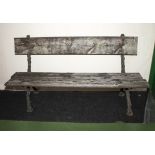A Victorian garden bench with cast iron supports and wooden boards