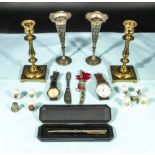 An assorted lot of candlesticks, bud vases, watches, thimbles and other items