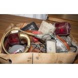 A box containing vintage brake lights, car horn and other car accessories