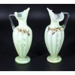 A pair of Victorian vaseline glass ewers