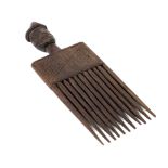 A West African carved wooden comb