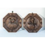 A pair of Continental carved wooden plaques