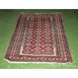 A red ground wool rug 135cm x 185cm