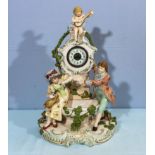 A reproduction pottery clock styled as a water fountain with figures, 40cm tall