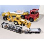 An ERTL International Harvester Backhoe together with other diecast vehicles and a truck
