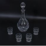 A cut glass decanter and four shot glasses