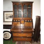 An unusual Georgian inlaid oak bureau bookcase. Provenance: Being the property of the late Kenneth