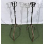 A pair of wrought iron inglenook fire dogs with bottle warmers