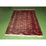 A red ground wool rug 125cm x 200cm