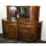 An Edwardian inlaid mahogany serpentine front sideboard