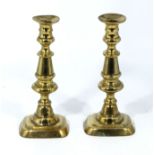 A pair of antique brass candle sticks.