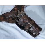 A replica Western 6 shooter revolver with holster and belt