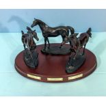 Three metal horses, Byerley Turk, Darley Arabian and Godolphin Arabian on wooden plinth