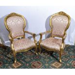 A pair of gold painted arm chairs