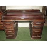 A mahogany rolltop pedestal desk.