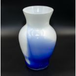 A white and blue art glass vase