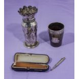 A small silver rimmed horn beaker, gold tipped amber cigar holder in case, a white metal vase and