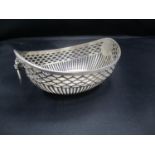 A white metal and pierced twin handled dish, 93.55g