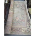 An Oriental Kayam carpet having a pale pastel coloured ground and a floral design 273 x 353cm