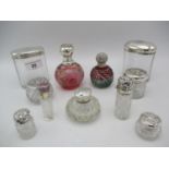 A collection of late Victorian/early Edwardian silver topped glass scent and dressing table