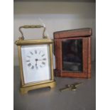 A French brass cased carriage clock, five windows, presentation inscription to top, in leather box