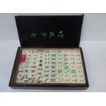 A mid 20th century Mah Jong set with resin and bamboo counters to include Jokers contained in a