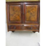 A walnut wall hanging cabinet having two small drawers and two cupboard doors 45 h x 41 w x 21cm d