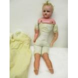 An Edwardian doll with a wax head, shoulders, forearms and lower legs, 16 1/2" h, the body stamped